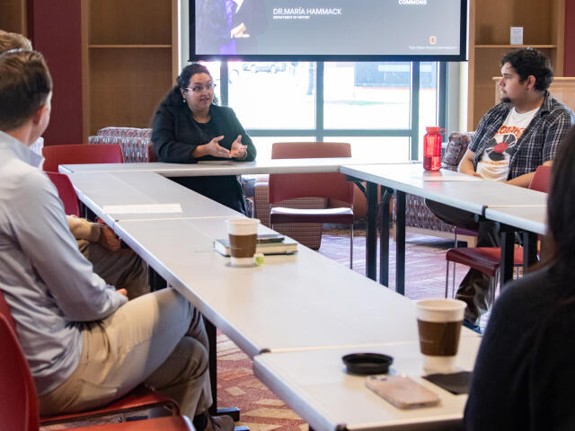 Professor sharing their story with a group of students
