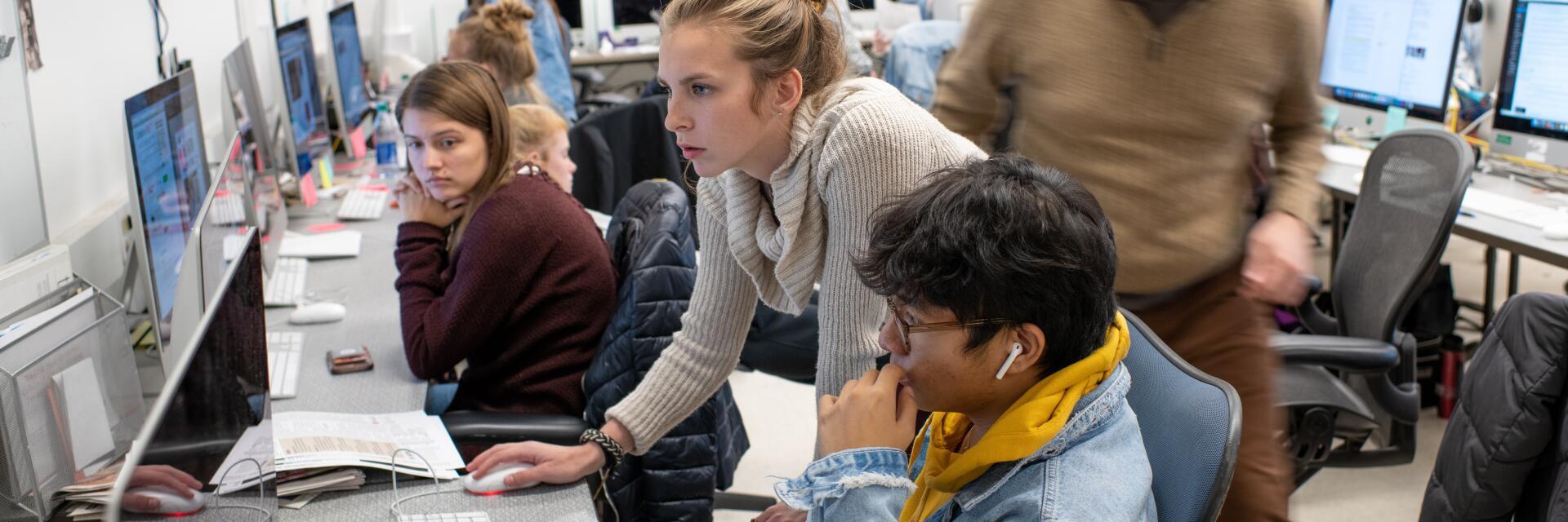 Student recieving guidance on a computer
